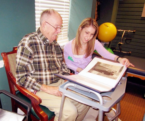 therapist and resident looking at scrapbook